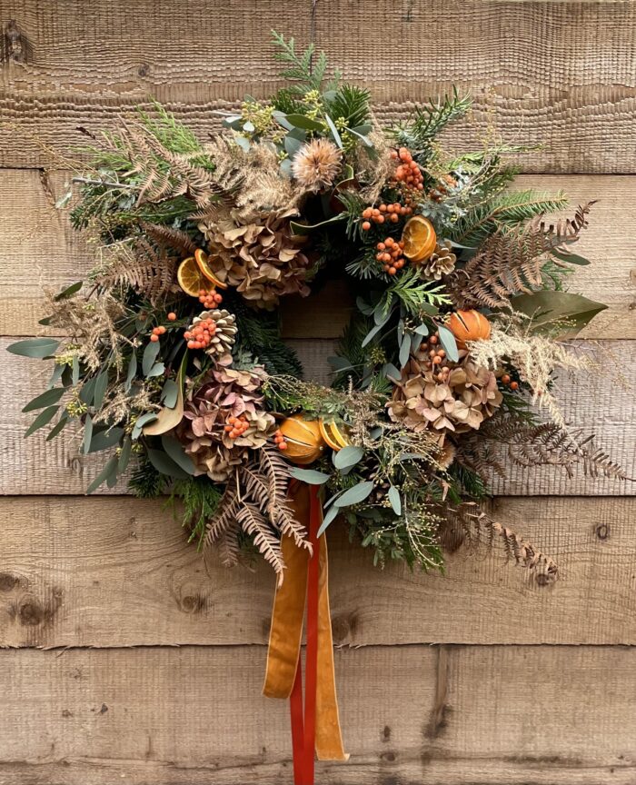 Handmade wreath in orange and dried flowers